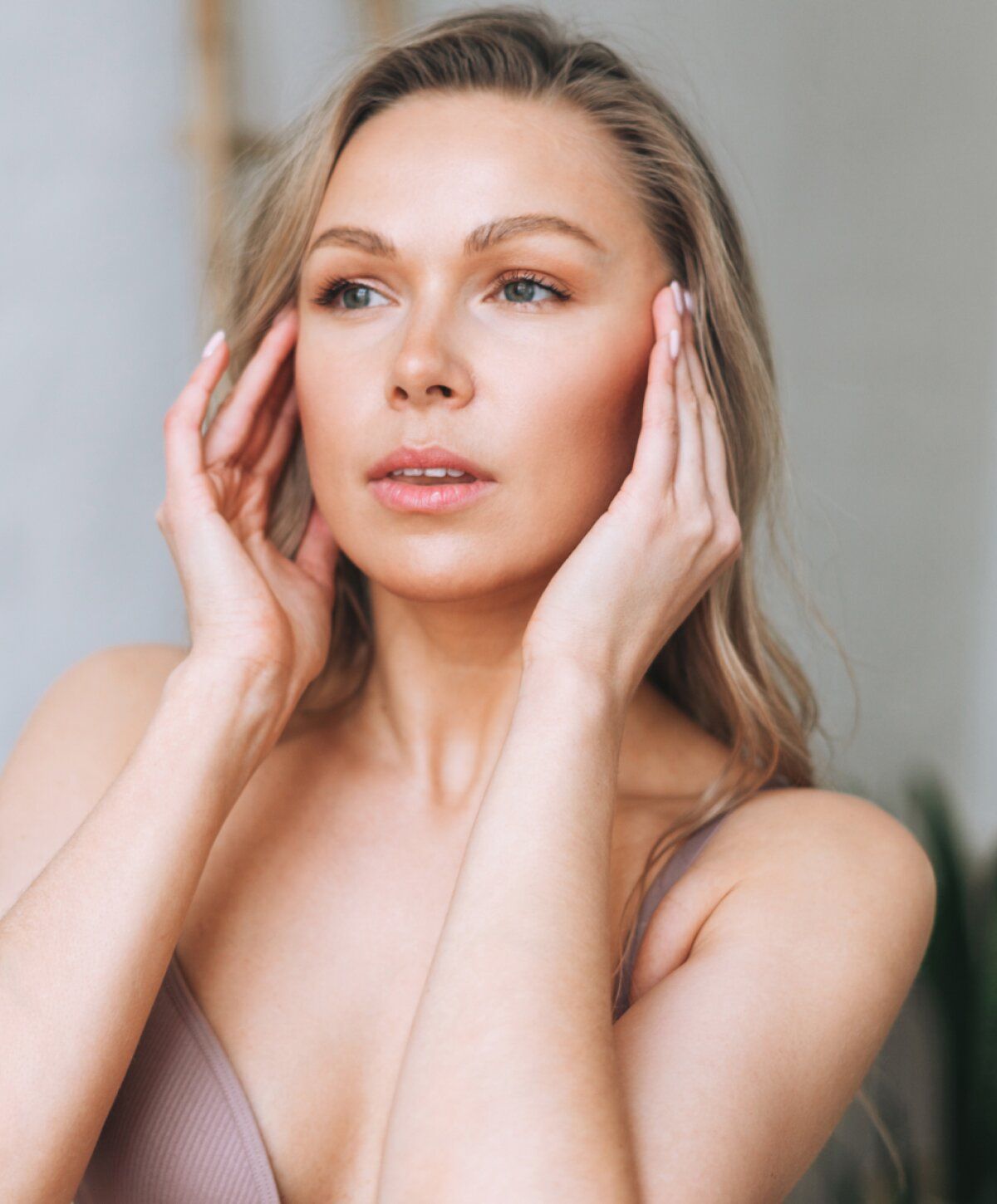 Young woman with hands on her face.