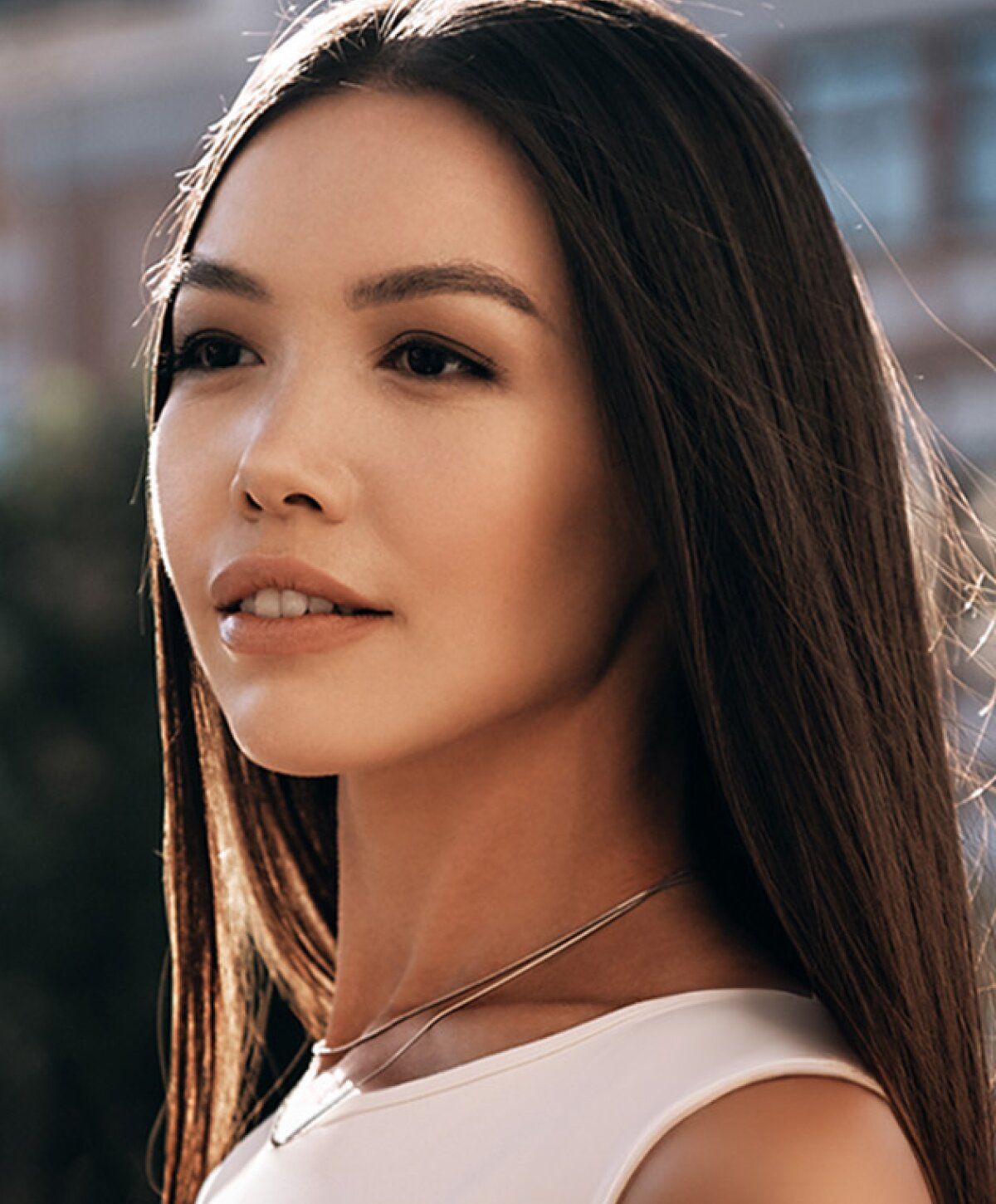 Woman with curly hair in stylish outfit.