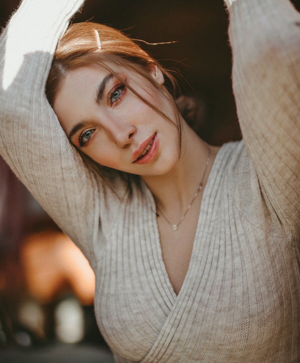 Woman in soft sweater with natural light background.