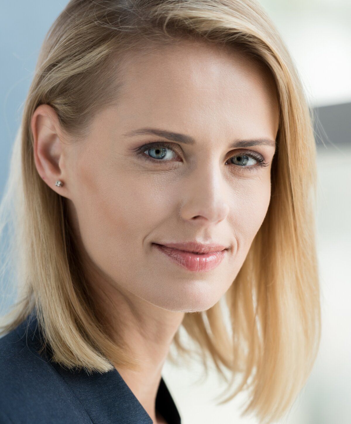 Professional woman with blonde hair and blue eyes.