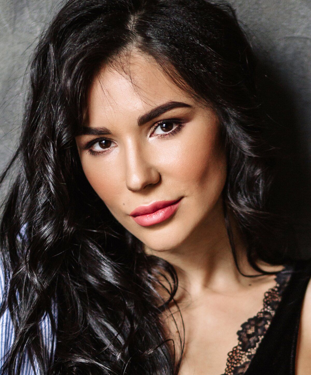 Portrait of a woman with long, wavy hair.