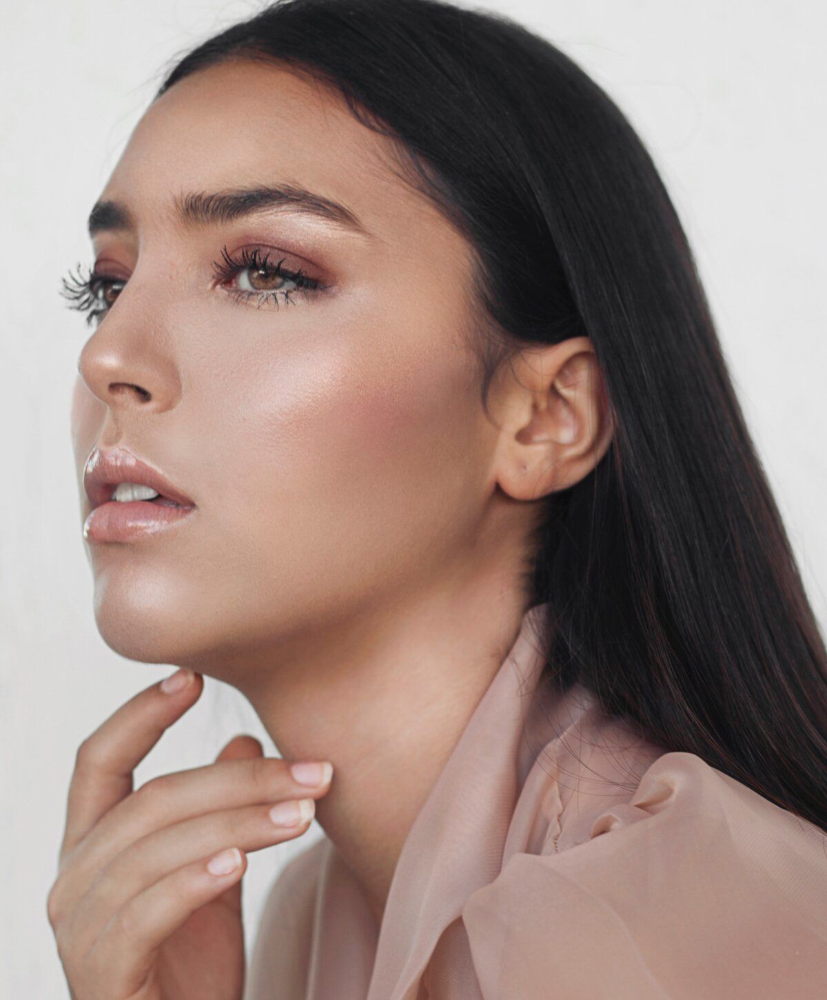Profile portrait of a woman with elegant makeup.